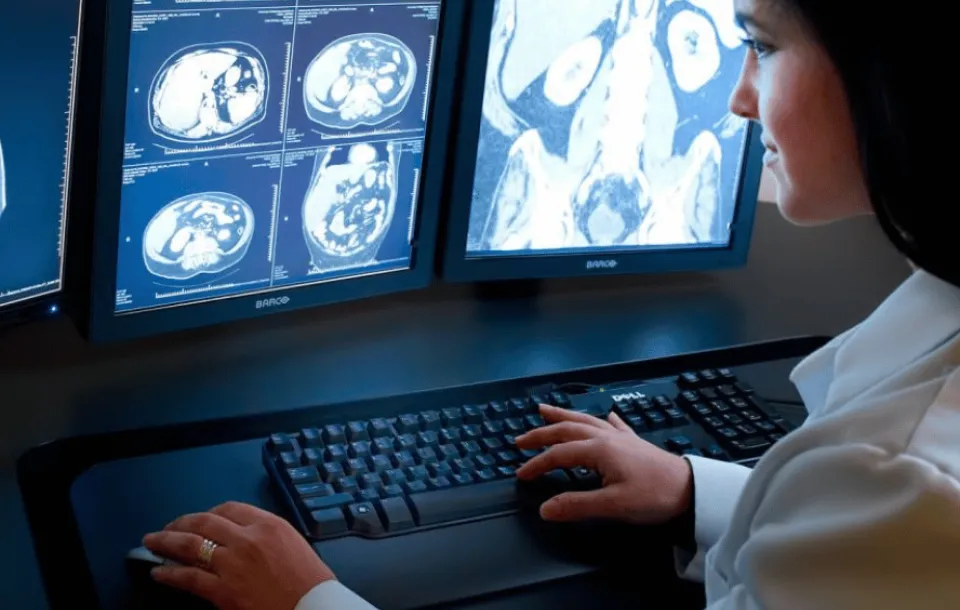 Scene suggesting a radiologist dictating medical findings, likely for patient records.
